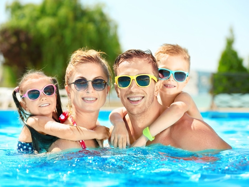 Happy family in swimming pool at water park